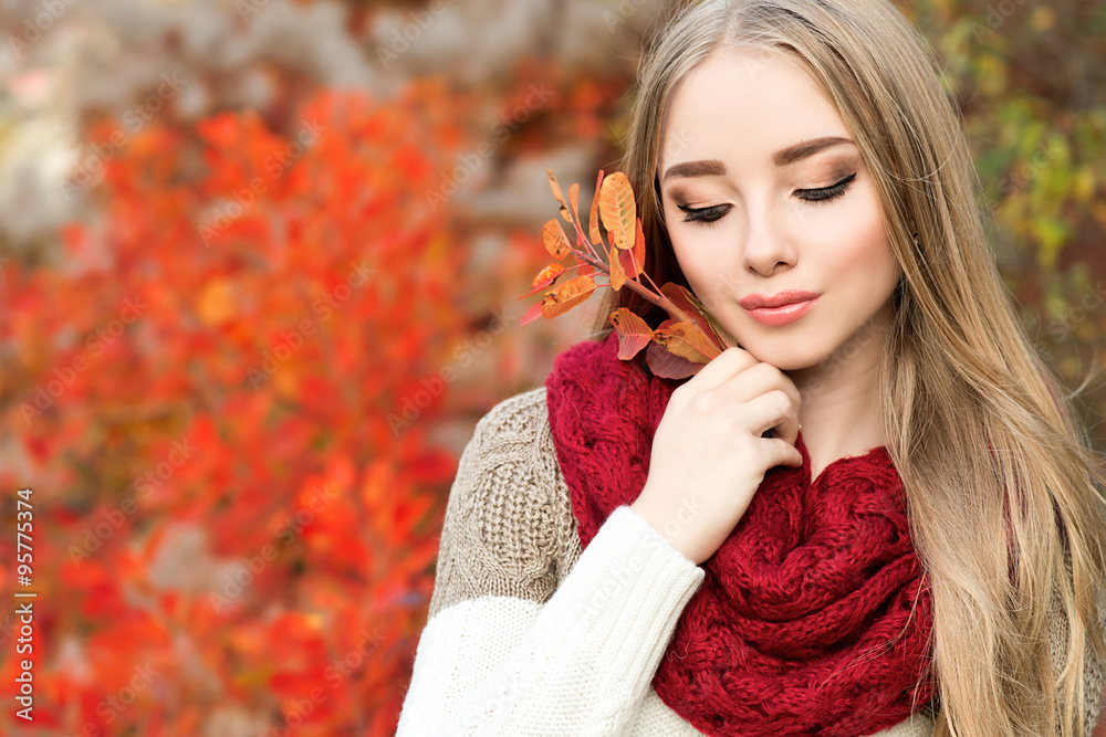 Beautiful young woman walking outdoors in autumn
Beautiful young woman walking outdoors in autumn