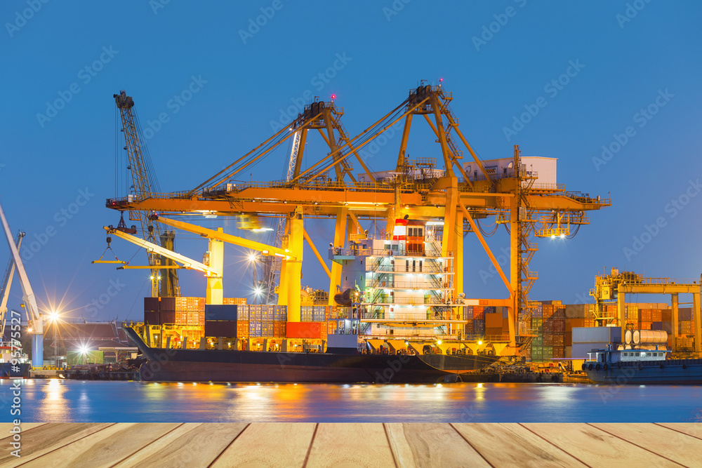 Gantry crane loading and unloading cargo container from cargo ship at port to show global international logistics and transportation by cargo ship and cargo container, Logistic import export concept. Gantry crane loading and unloading cargo container from cargo ship at port to show global international logistics and transportation by cargo ship and cargo container, Logistic import export concept.