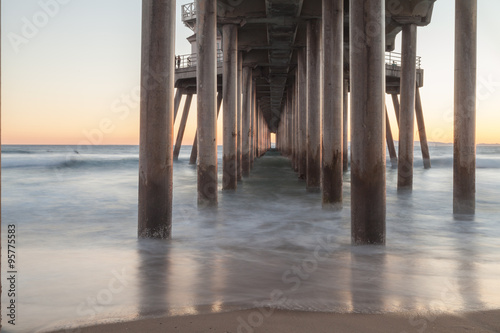 Under the Huntington Beach, California pier at sunset in the fall