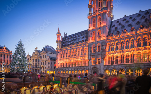 Lights show in Grand Place of Brussels Belgium and a huge Christmas tree with a crowd of unidentified people enjoying the celebration atmosphere

