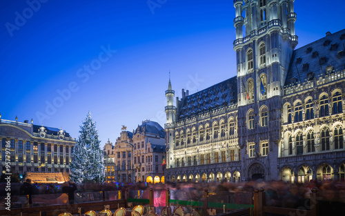 Lights show in Grand Place of Brussels Belgium and a huge Christmas tree with a crowd of unidentified people enjoying the celebration atmosphere 
