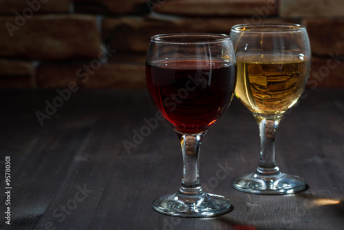 two glasses of wine on the background of a brick wall