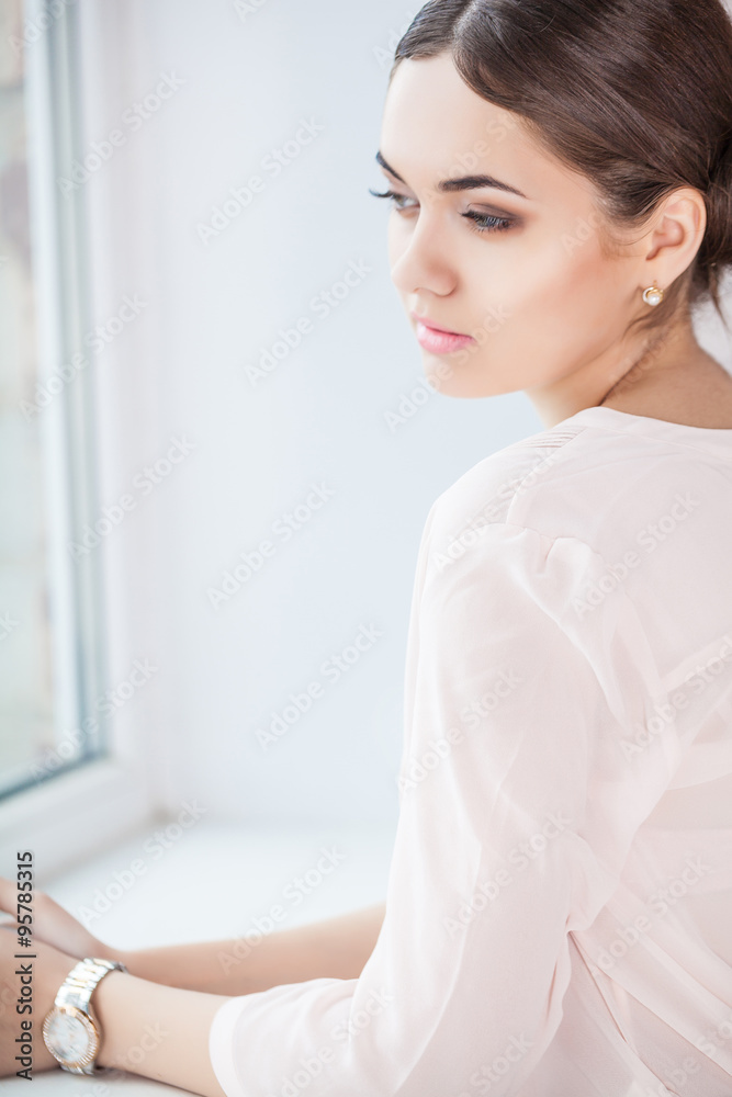 Businesswoman standing in front of window indoor Businesswoman standing in front of window indoor