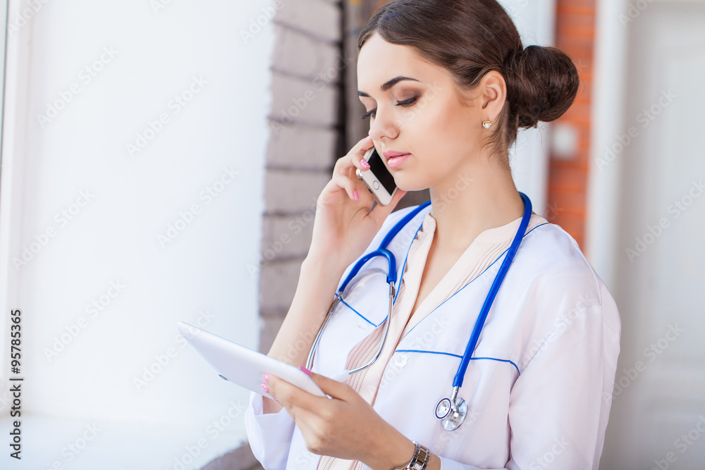 Female doctor looking at medical records on tablet computer at hospital Female doctor looking at medical records on tablet computer at hospital