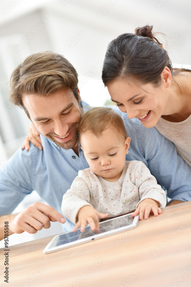 Parents with baby gril playing with digital tablet Parents with baby gril playing with digital tablet
