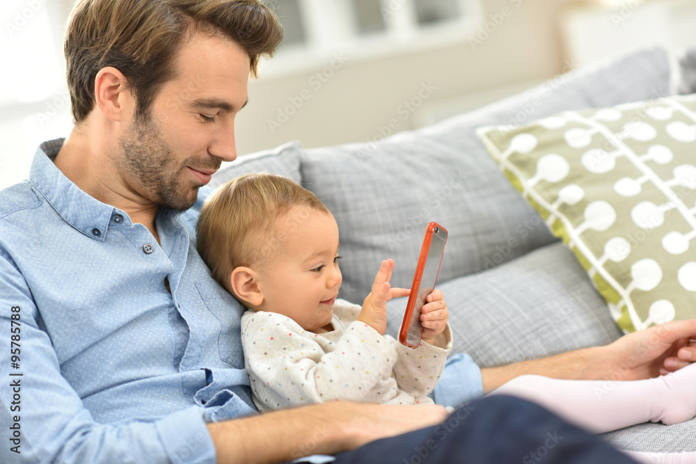 Daddy and baby girl playing with smartphone Daddy and baby girl playing with smartphone