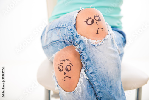 divorce in the family. Sad smiley on jeans.  men and women turned away, the couple quarrel, drawn in a lap detuned person,
face turned away
 photo