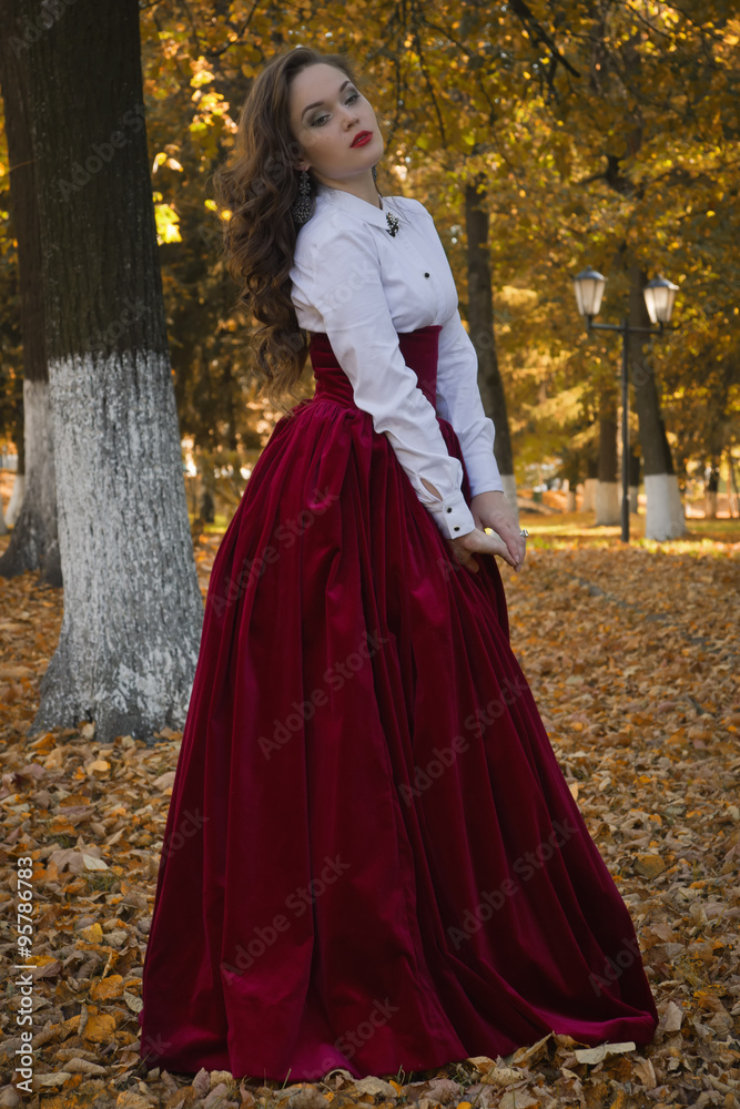 Woman dressed in a retro-style on the autumn alley Woman dressed in a retro-style on the autumn alley