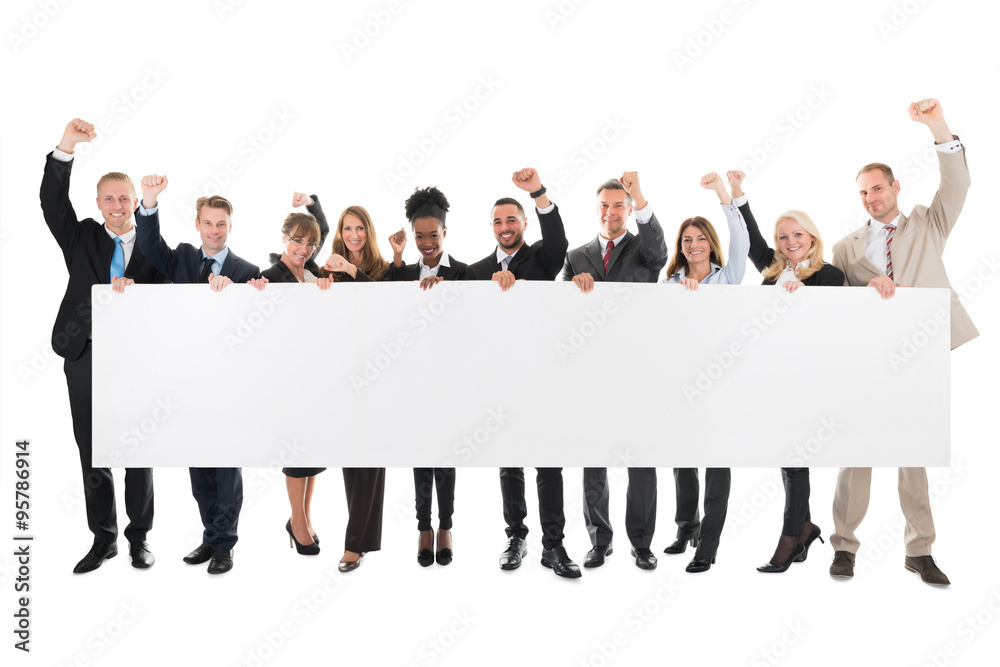 Obraz premium Happy Business Team With Arms Raised Holding Blank Billboard