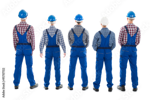 Rear View Of Male Carpenters Standing In Row