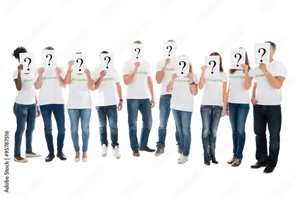 Obraz premium Volunteers Covering Faces With Question Mark Signs