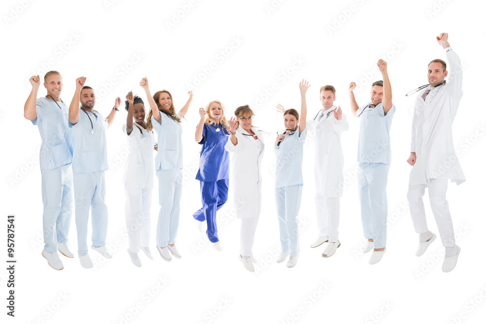Multiethnic Medical Team Standing With Arms Raised Multiethnic Medical Team Standing With Arms Raised