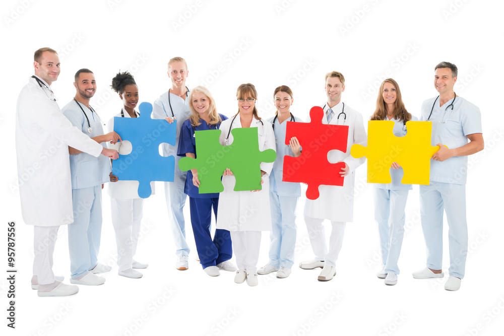 Obraz premium Confident Medical Team Holding Jigsaw Pieces