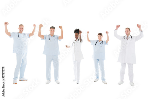 Multiethnic Medical Team Standing With Arms Raised