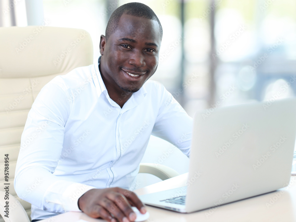 Image of african american businessman working on his laptop. Image of african american businessman working on his laptop.