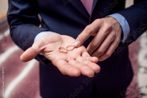 Wedding rings in groom's hand