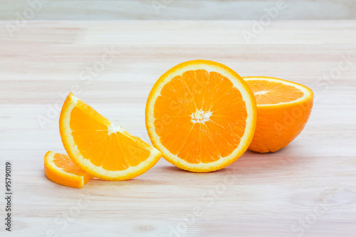 Slice of fresh orange on wooden background