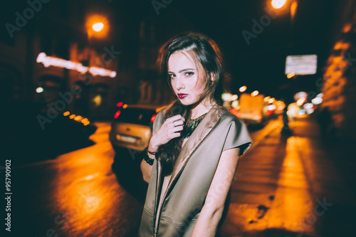 Sexy gorgeous brunette girl portrait in night city lights. Motion effect.