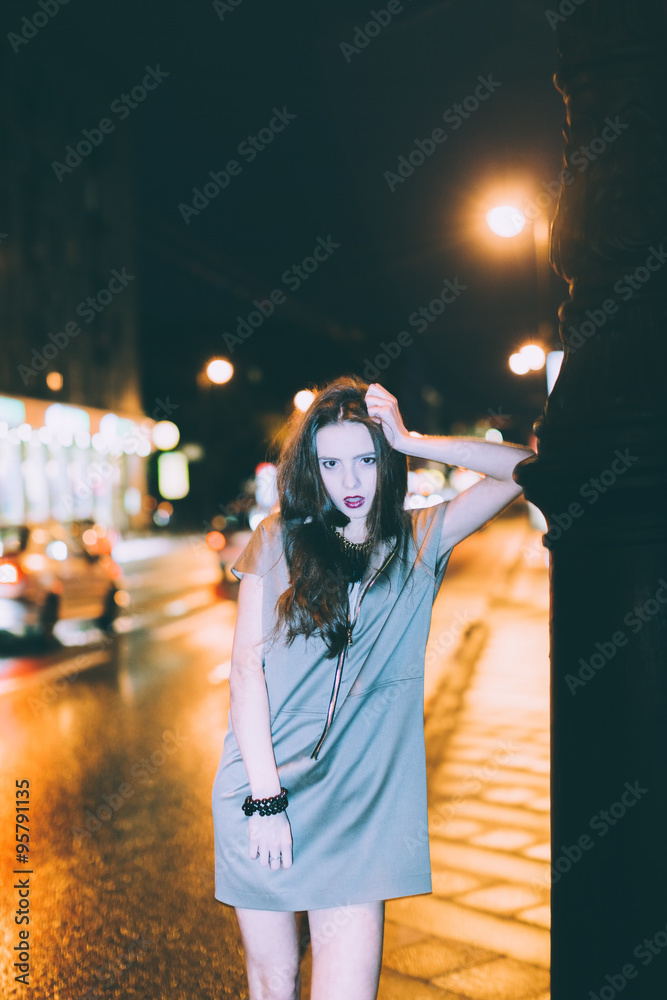 Sexy gorgeous brunette girl portrait in night city lights. Motion effect.