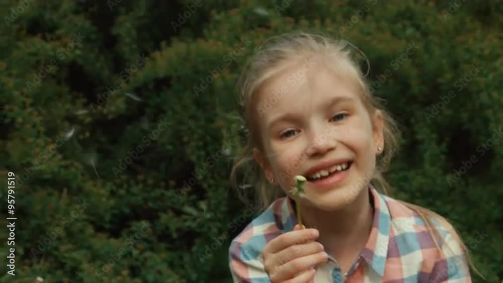 Girl blowing dandelion parachutes. Thumbs up. Ok Girl blowing dandelion parachutes. Thumbs up. Ok
