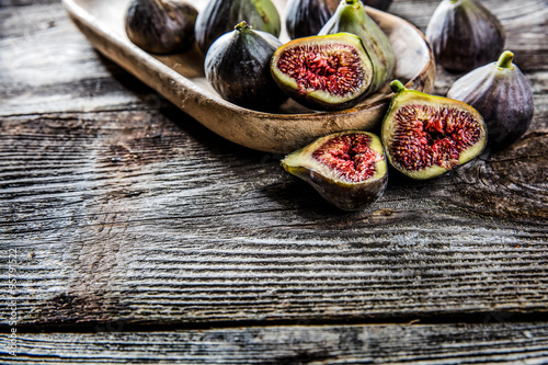 tray of fresh ripe figs on authentic rustic wooden table background 