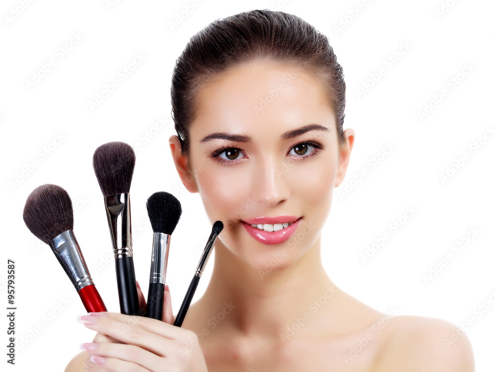 Pretty woman with makeup brushes, isolated on white Pretty woman with makeup brushes, isolated on white
