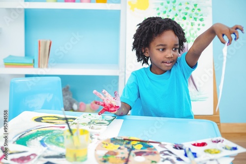 Happy kid enjoying arts and crafts painting