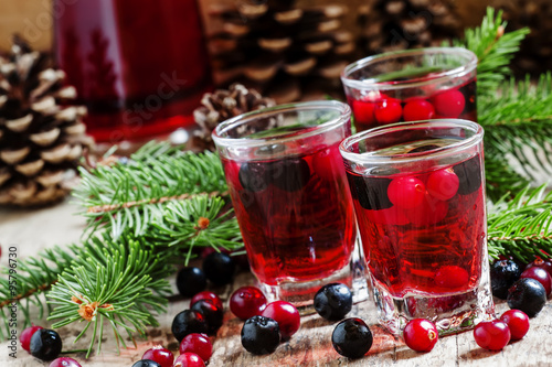 Winter drink with cranberry, cowberry and black chokeberry on th
