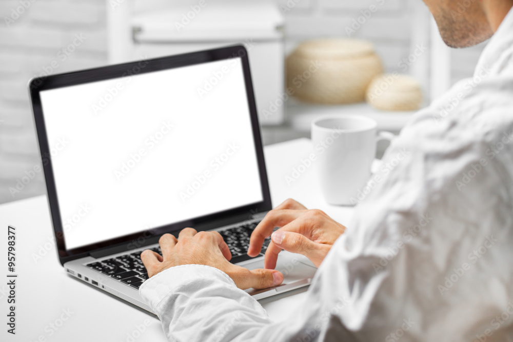 Cropped shot of a man's hands using a laptop at home Cropped shot of a man's hands using a laptop at home