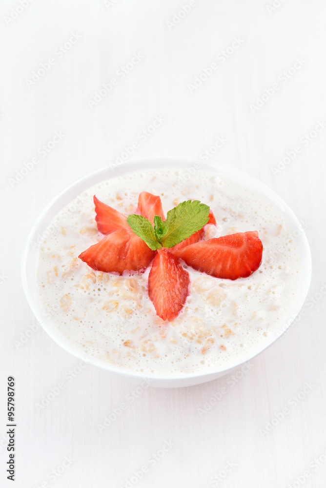 Oatmeal porridge with strawberry slices Oatmeal porridge with strawberry slices
