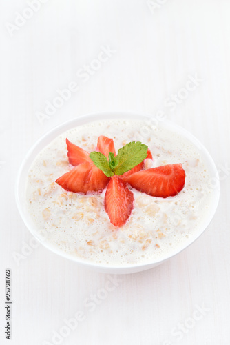 Oatmeal porridge with strawberry slices