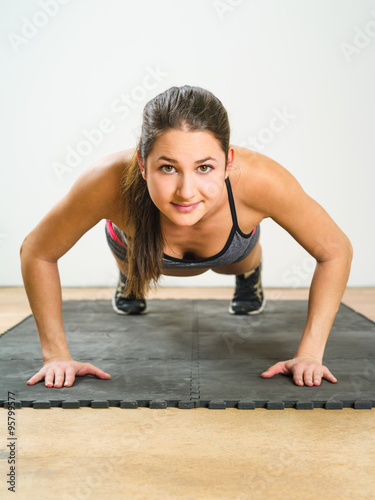 Young woman doing pushups