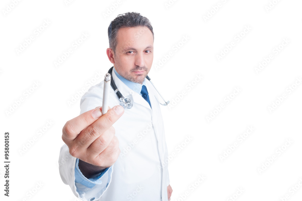 Young doctor or medic showing lighted cigarette to the camera Young doctor or medic showing lighted cigarette to the camera