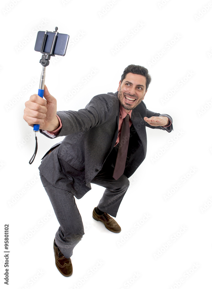 young attractive businessman in suit and tie taking selfie photo with mobile phone camera and stick posing happy young attractive businessman in suit and tie taking selfie photo with mobile phone camera and stick posing happy