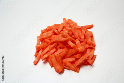 Carrots, cut into large strips on a white background