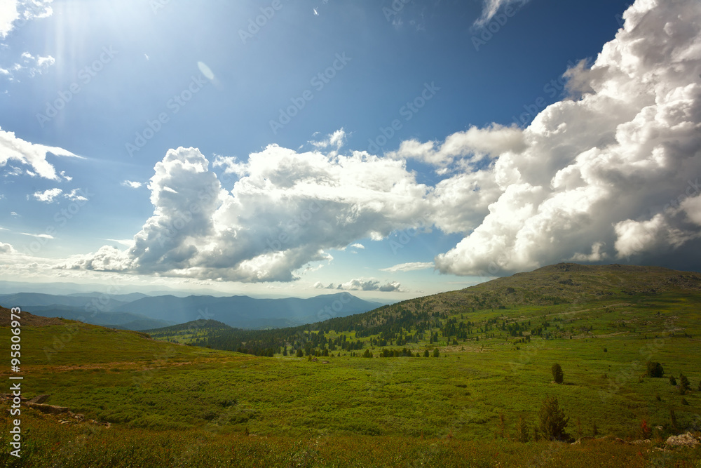 Beautiful mountain landscape with white clouds in the blue sky