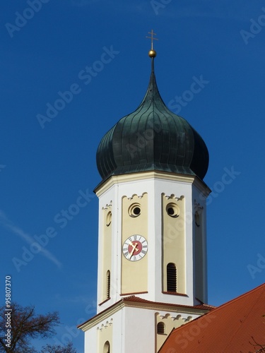 Zwiebelturm im Barockstil der katholischen Kirche St. Cosmas und Damian vor blauem Himmel im Sonnenschein in Burgheim im Landkreis Neuburg Schrobenhausen in Oberbayern photo