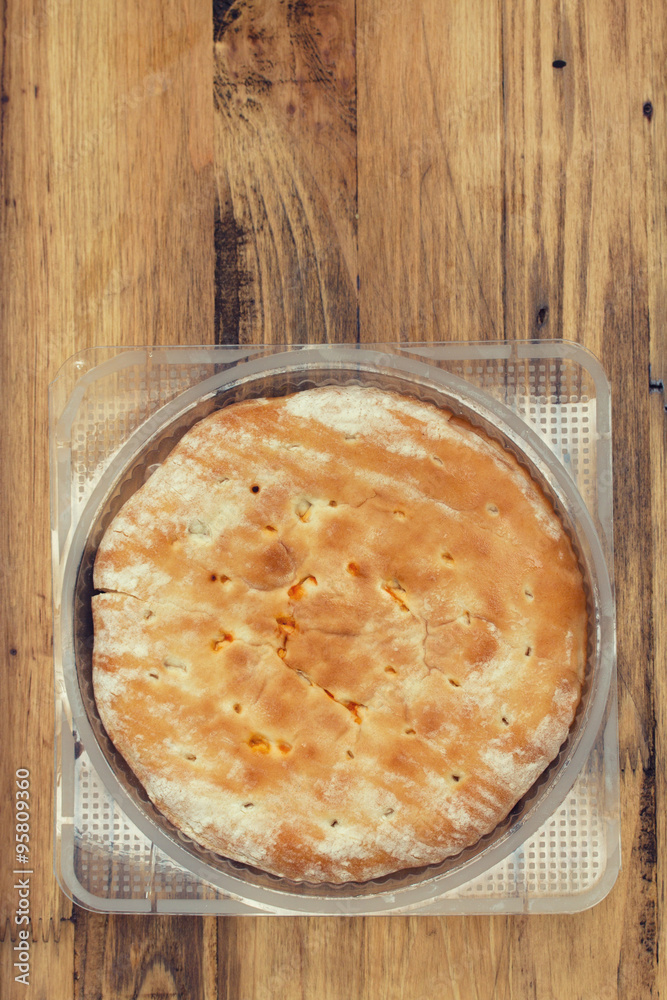 calzone in plastic bag on brown background calzone in plastic bag on brown background