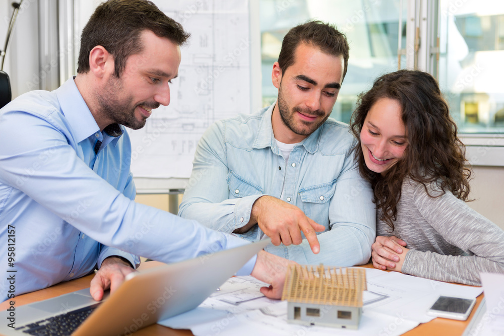 Fototapeta premium Young attractive people meeting real estate agent at the office