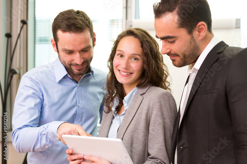 Young attractive businesswoman working at the office with associ photo