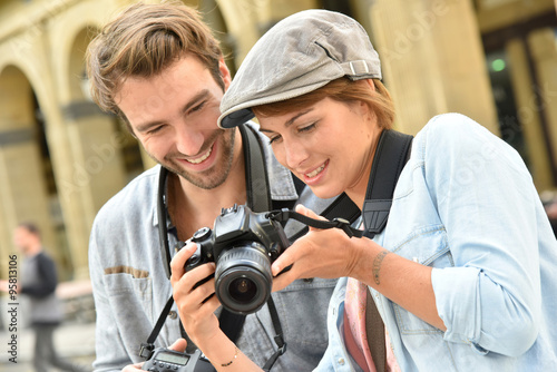 Young people doing a photo reportage in town