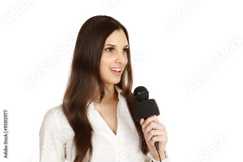 A young woman with a microphone looking "off screen" as if interviewing someone.