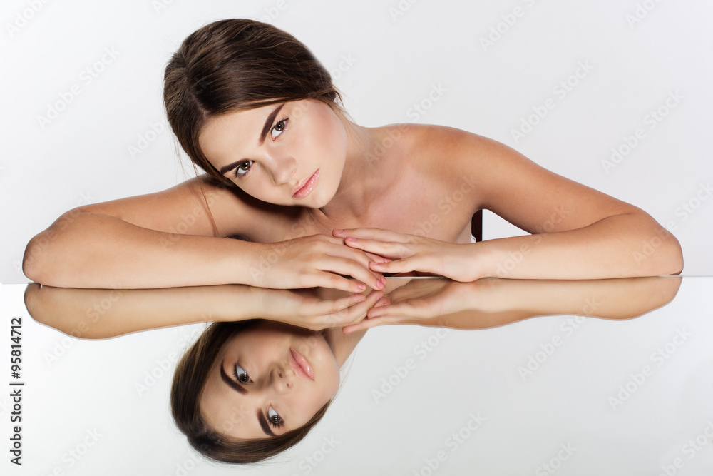 Beautiful girl and her reflexion in the mirror Beautiful girl and her reflexion in the mirror