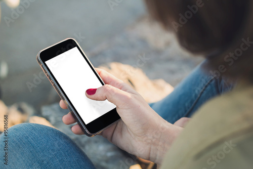 Woman touch the screen of her smartphone photo