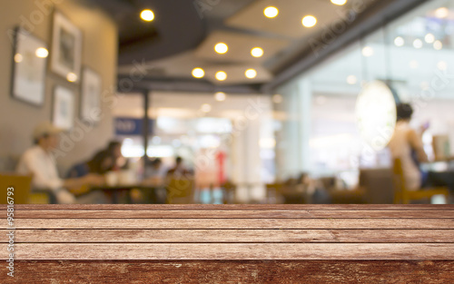 Empty wood table top with restaurant blur with bokeh background,Product display template