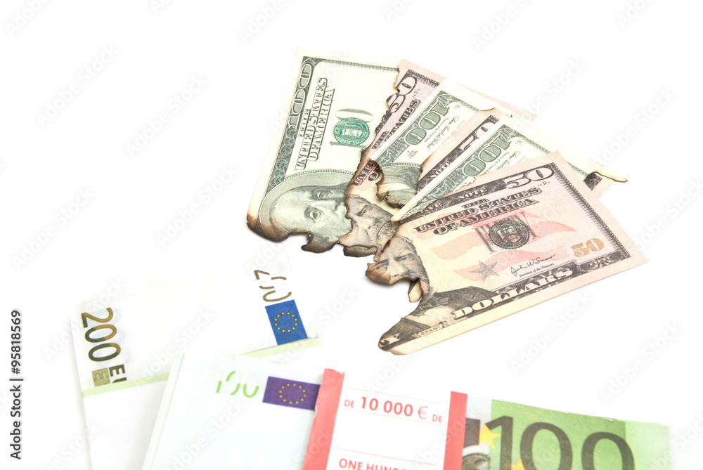 euros and burned dollars banknotes on white euros and burned dollars banknotes on white