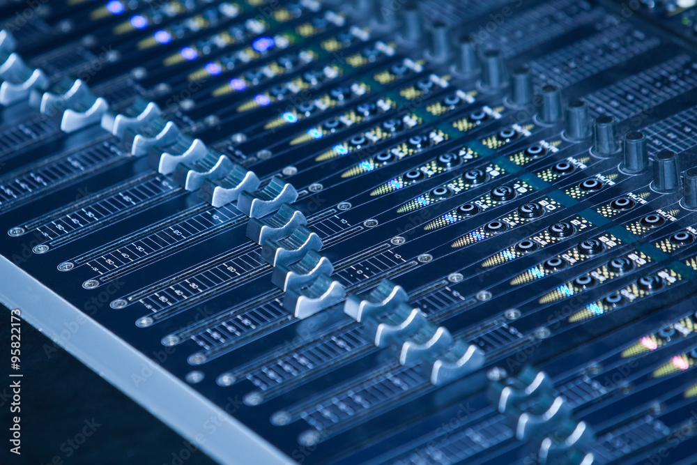 Console sound mixer closeup in blue