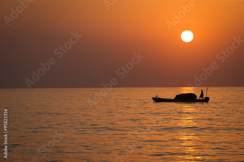 Tablou canvas Sunrise over the indian ocean with fishing boats