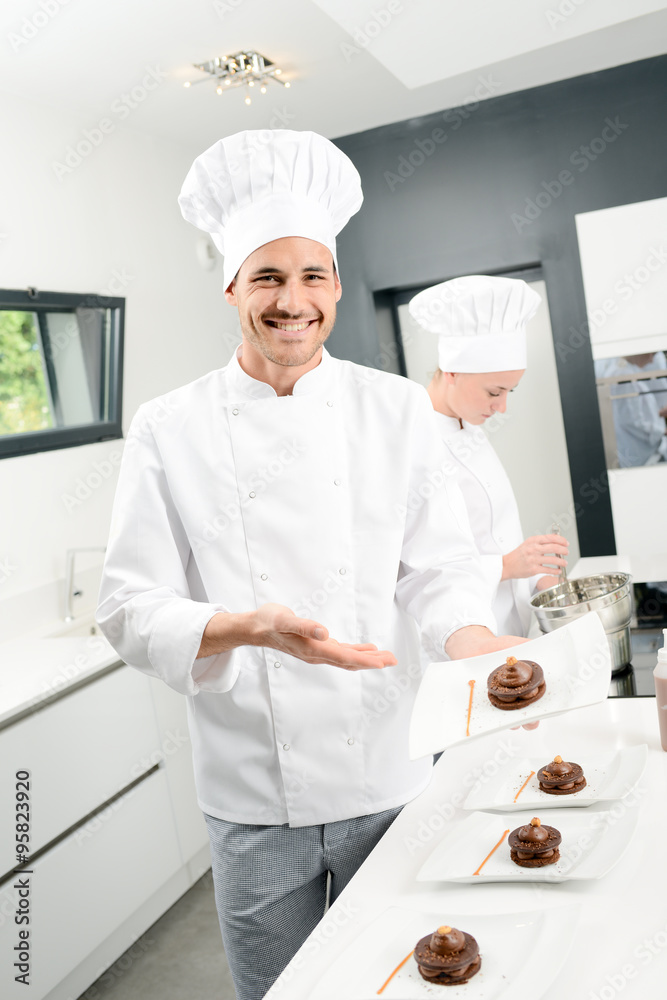 portrait of a handsome young man professional pastry cook preparing a chocolate dessert portrait of a handsome young man professional pastry cook preparing a chocolate dessert