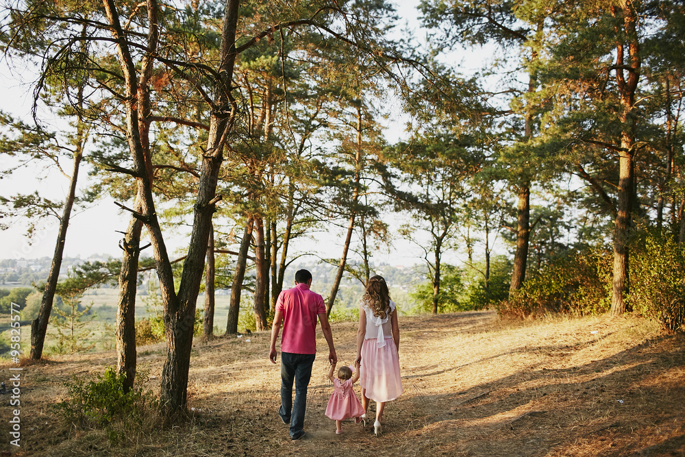 beautiful family of three people, mom dad and daughter